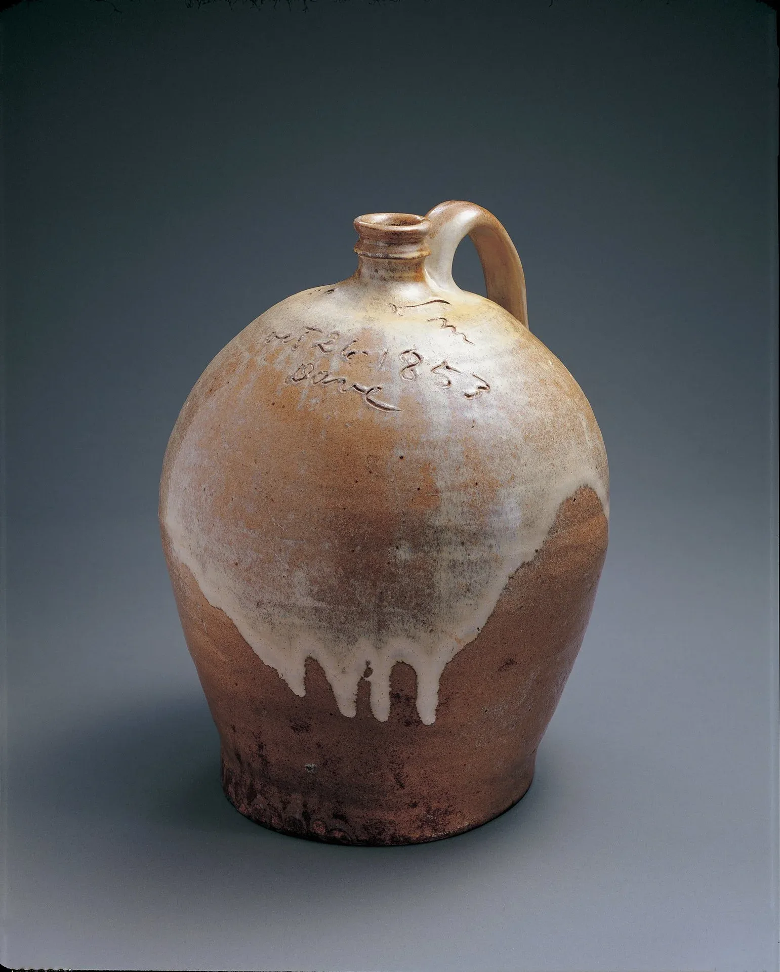  David Drake (c. 1800–c. 1870), Lewis J. Miles, Stony Bluff Plantation Pottery,  Jug , 1853, alkaline-glazed stoneware, 14 1/2 x 12 x 11 1/2 inches.&nbsp;Collection American Folk Art Museum, New York. Gift of Sally and Paul Hawkins, 1999.18.1. Photo by John Parnell. 