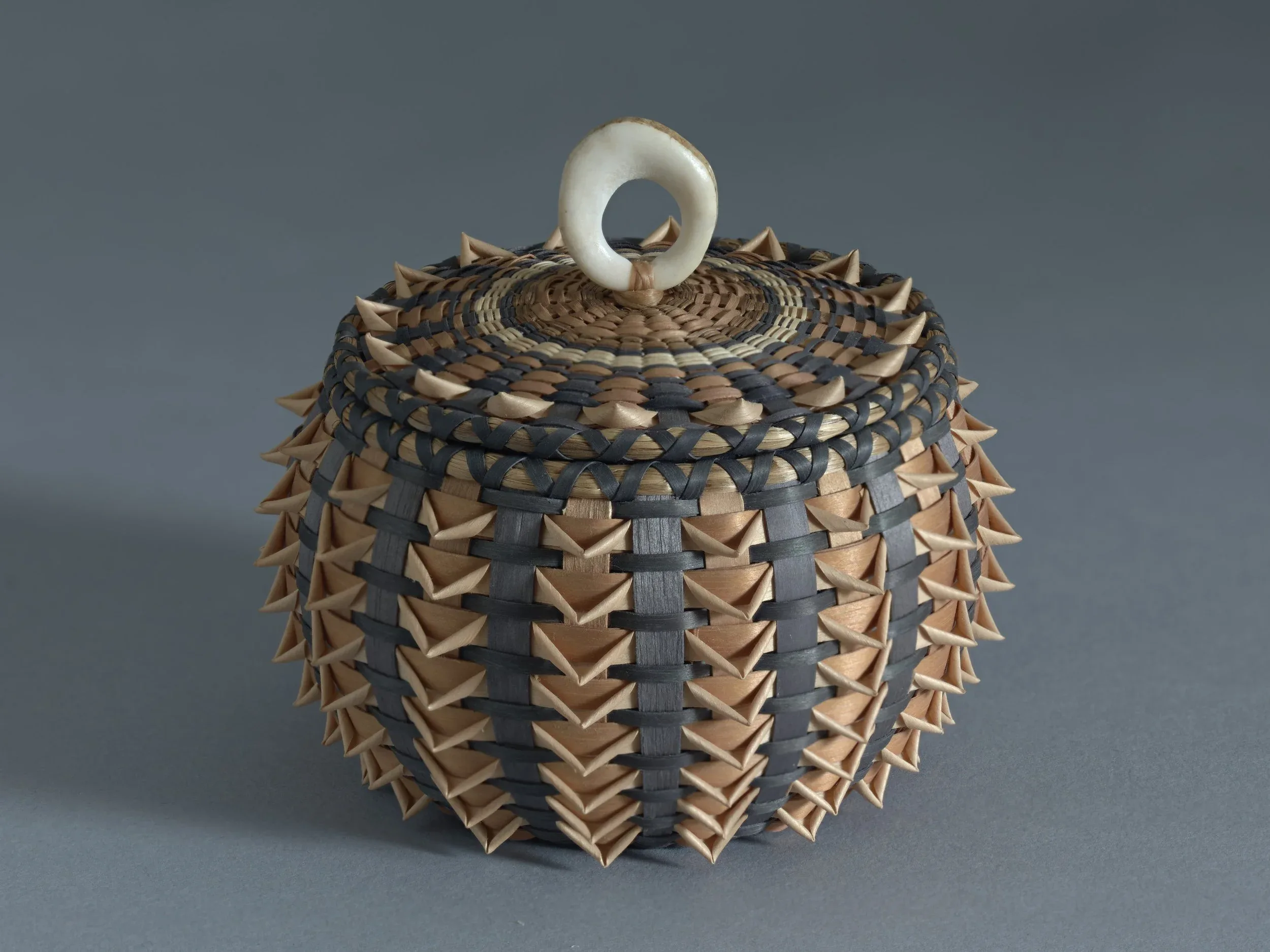 Sarah Sockbeson (Penobscot), Small urchin, black and brown, with points , black ash, sweetgrass, antler, dye, 3 3/4 x 4 x 4 inches. Gift of Barbara M. Goodbody, 2021.19.13a,b