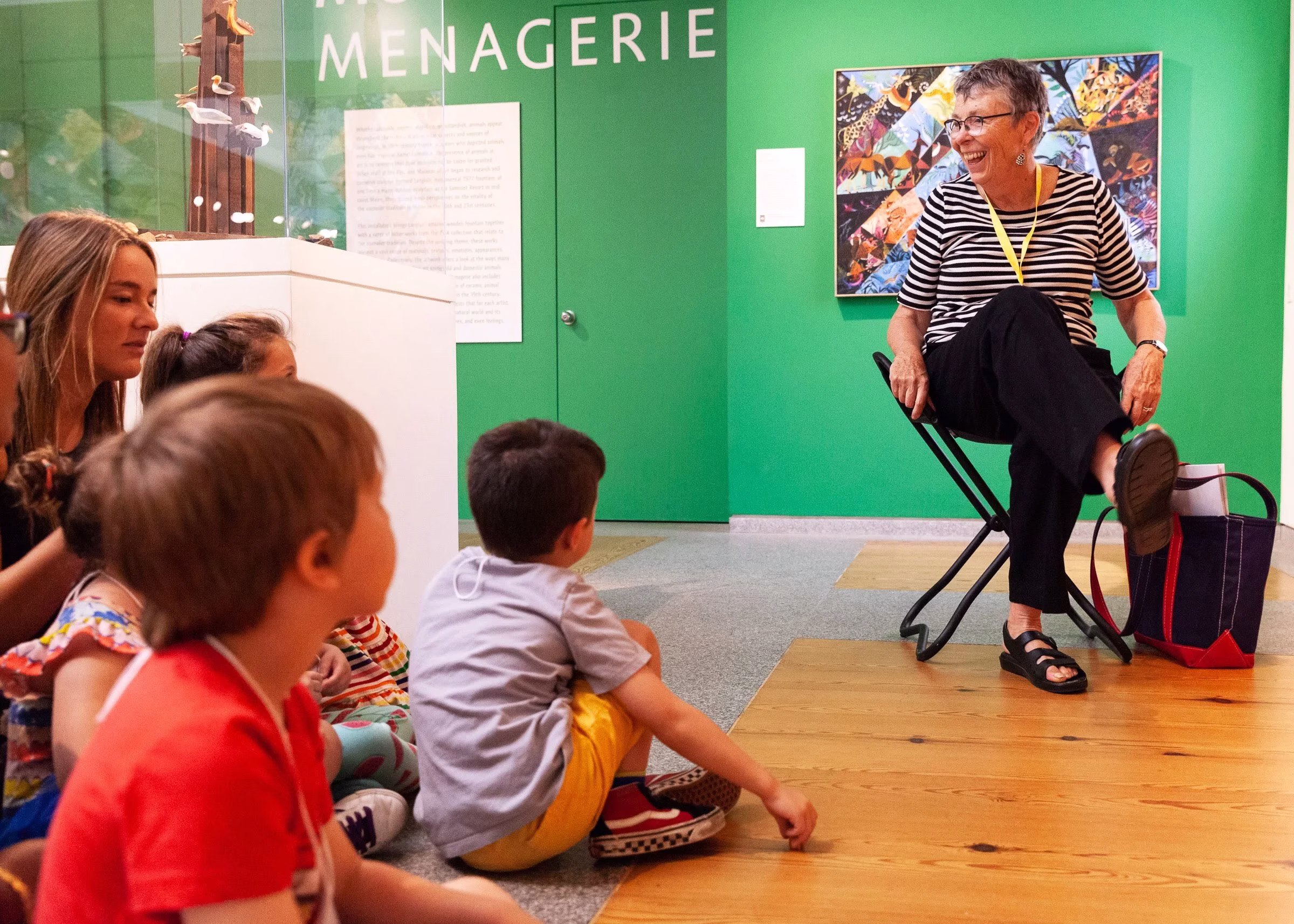 Senior woman laughing with kids in a museum.