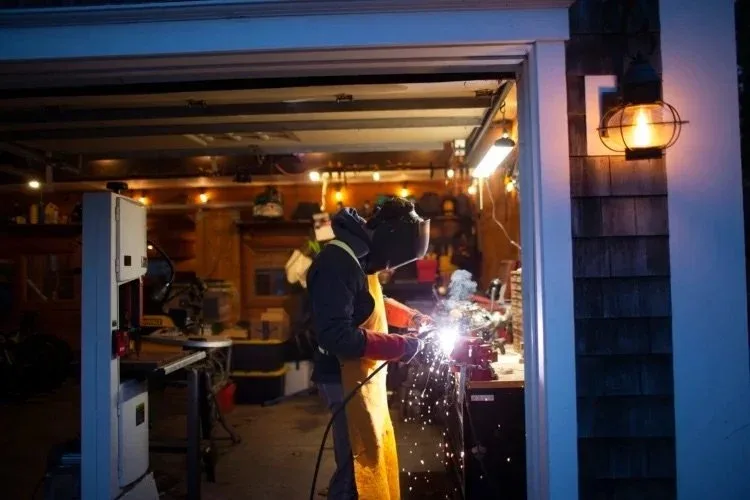 Benjamin Pochurek, 16, works in the garage of his home in Freeport, which serves as his work studio. Derek Davis/Staff Photographer
