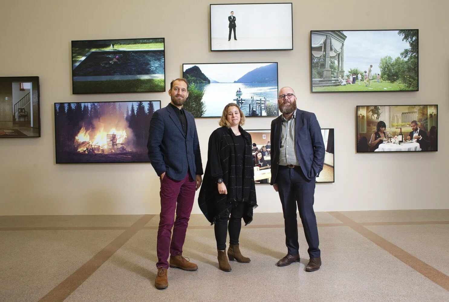 Curators Markús Þór Andrésson of the Rekyjavik Art Museum, Jaime DeSimone of the Portland Museum of Art and Anders Jansson of the Bildmuseet stand before a video installation by Icelandic artist Ragnar Kjartansson at the Portland Museum of Art, which is launching a new North Atlantic Triennial in 2021, replacing its 20-year-old biennial exhibition.