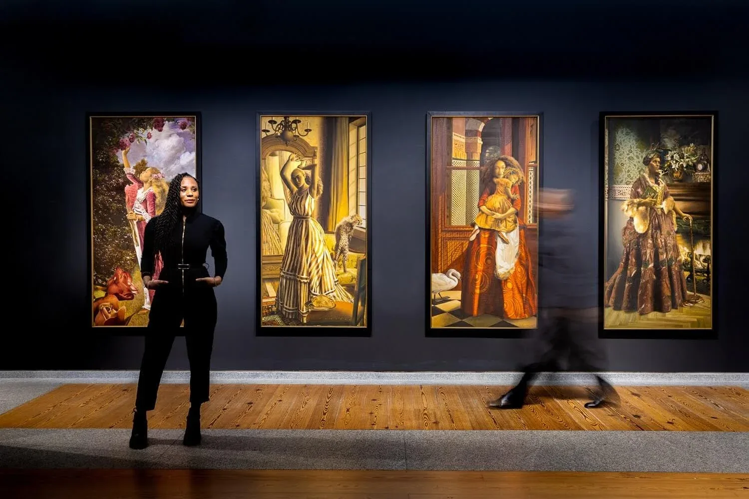 Elizabeth Colomba stands before her series Four Seasons (2012–2018) at “Mythologies,” on view at the Portland Museum of Art until September 3, 2023. Photo courtesy of the Portland Museum of Art.