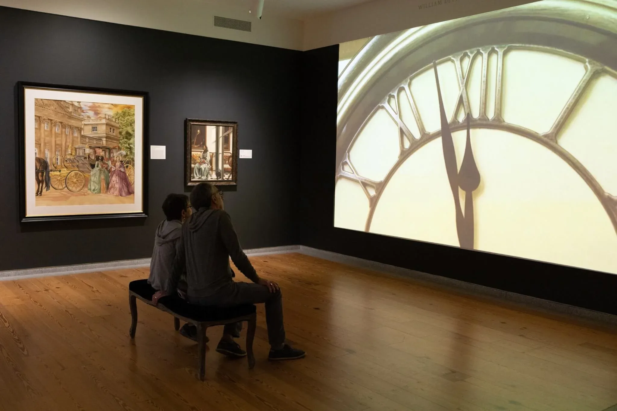 Visitors watch Elizabeth Colomba’s short film Cendrillon (2018) at “Mythologies,” on view at the Portland Museum of Art until September 3, 2023. Photo courtesy of the Portland Museum of Art.