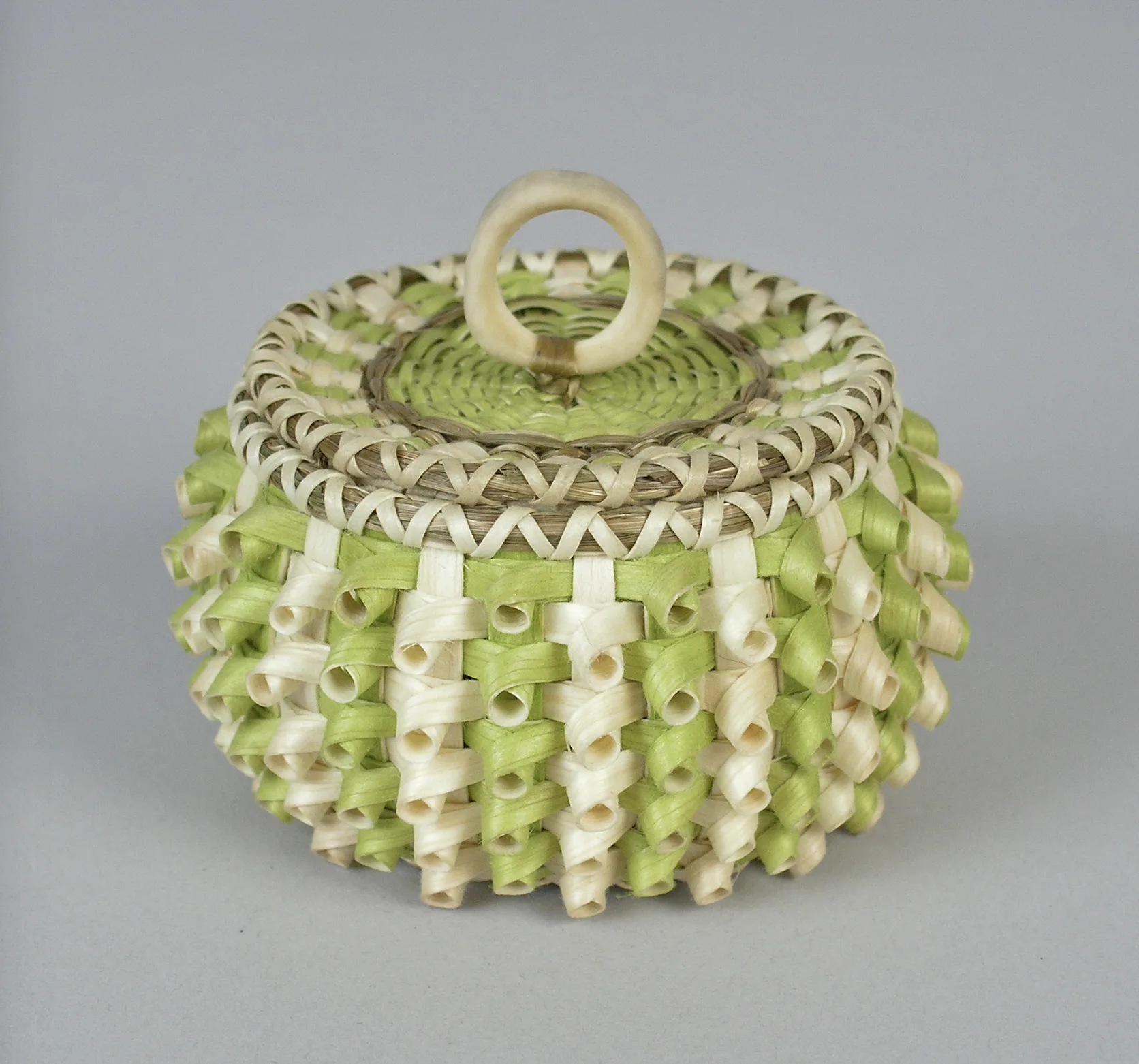 Sarah Sockbeson (Penobscot, born 1983) , Miniature Curly Basket, 2010, ash, sweetgrass, dye, and antler. From the collection of the Abbe Museum, Bar Harbor, Maine, RAM 2010-08-002 A-B.