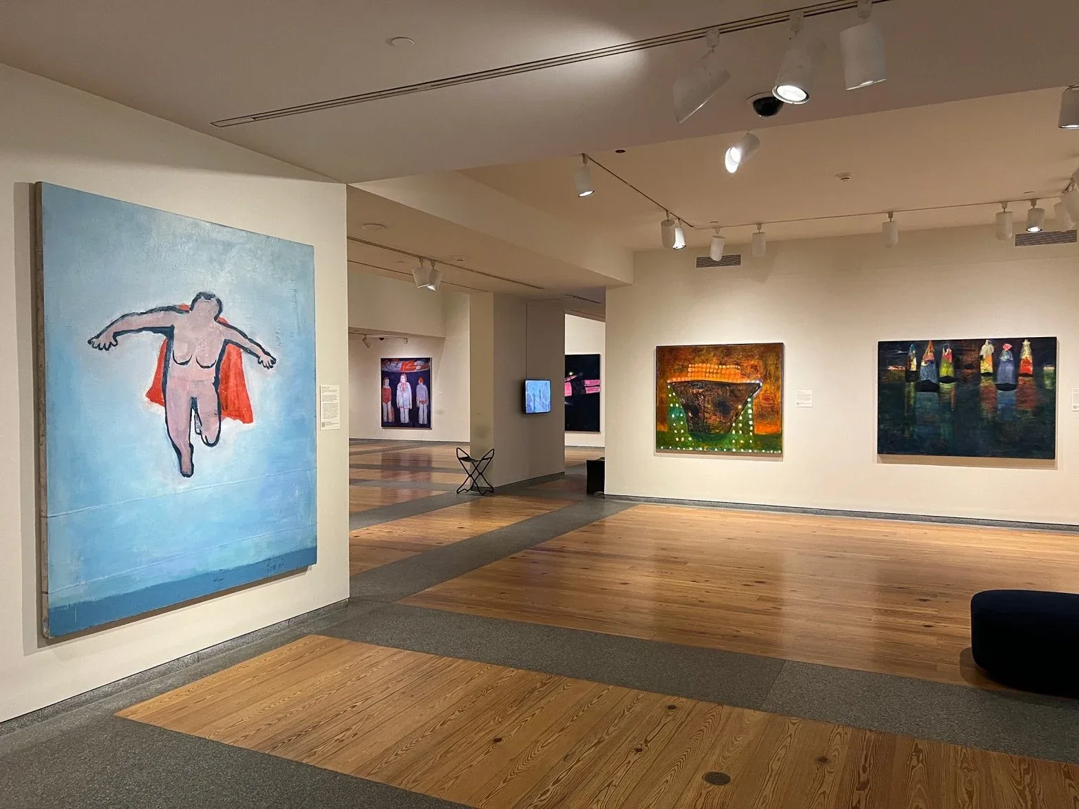 “Woman Flying” (1999), left, is the artist’s first superhero painting and considered a self-portrait. On the right wall you can also see “Sargasso” (2012) and “Desire For Transport” (2006).
